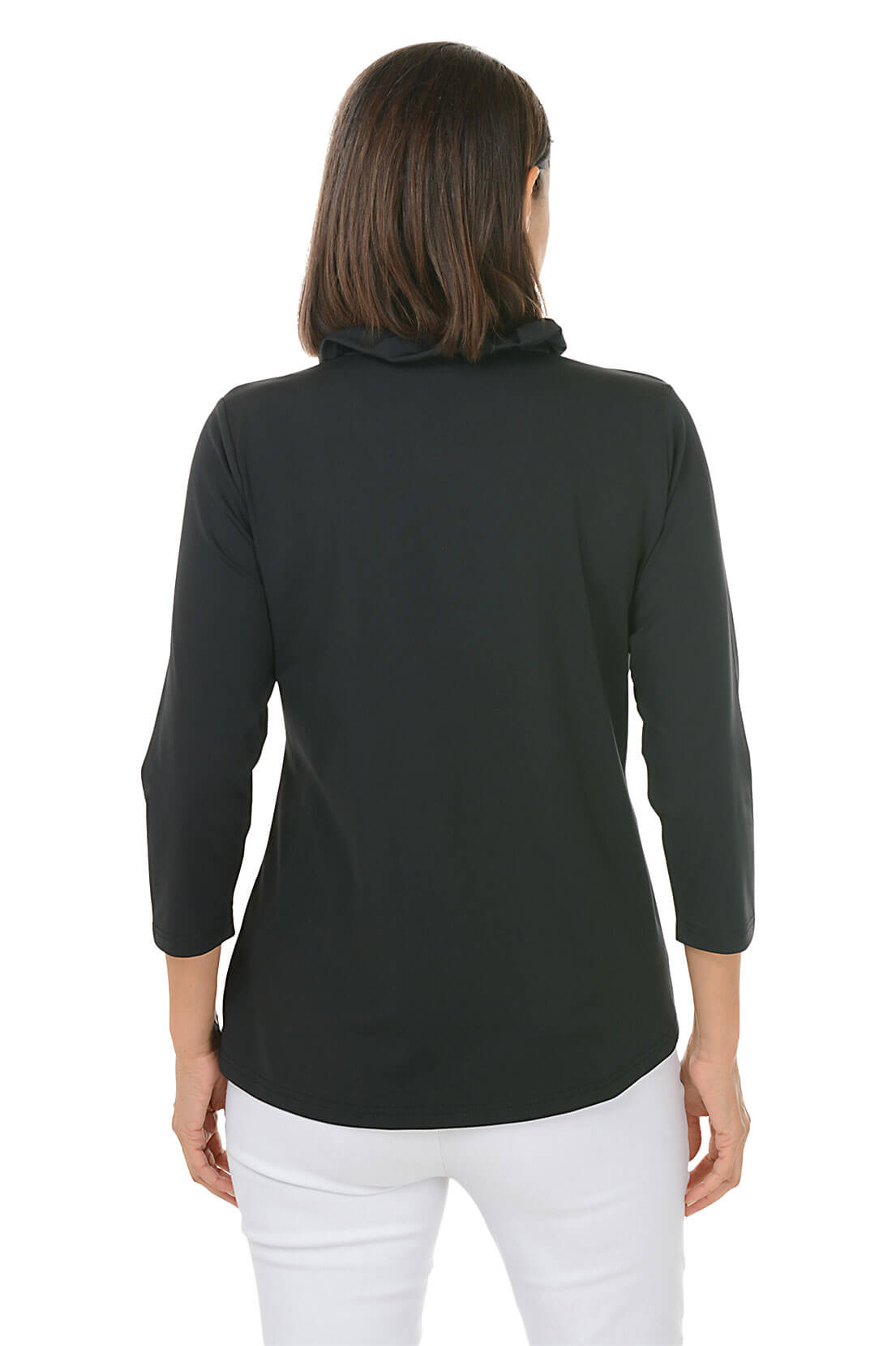 Woman wearing a black long-sleeve top and white pants on a white background
