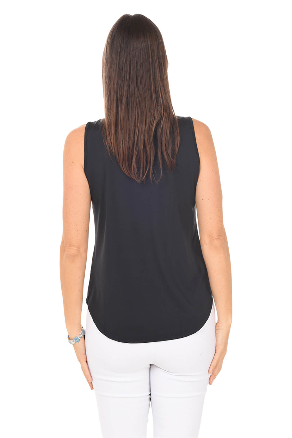Woman wearing a black sleeveless top and white pants on a white background. Back shot.