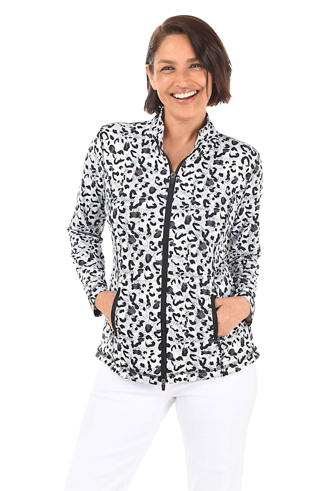 A woman wearing a black and white leopard-spotted zip front jacket and white pants in front of a white background.