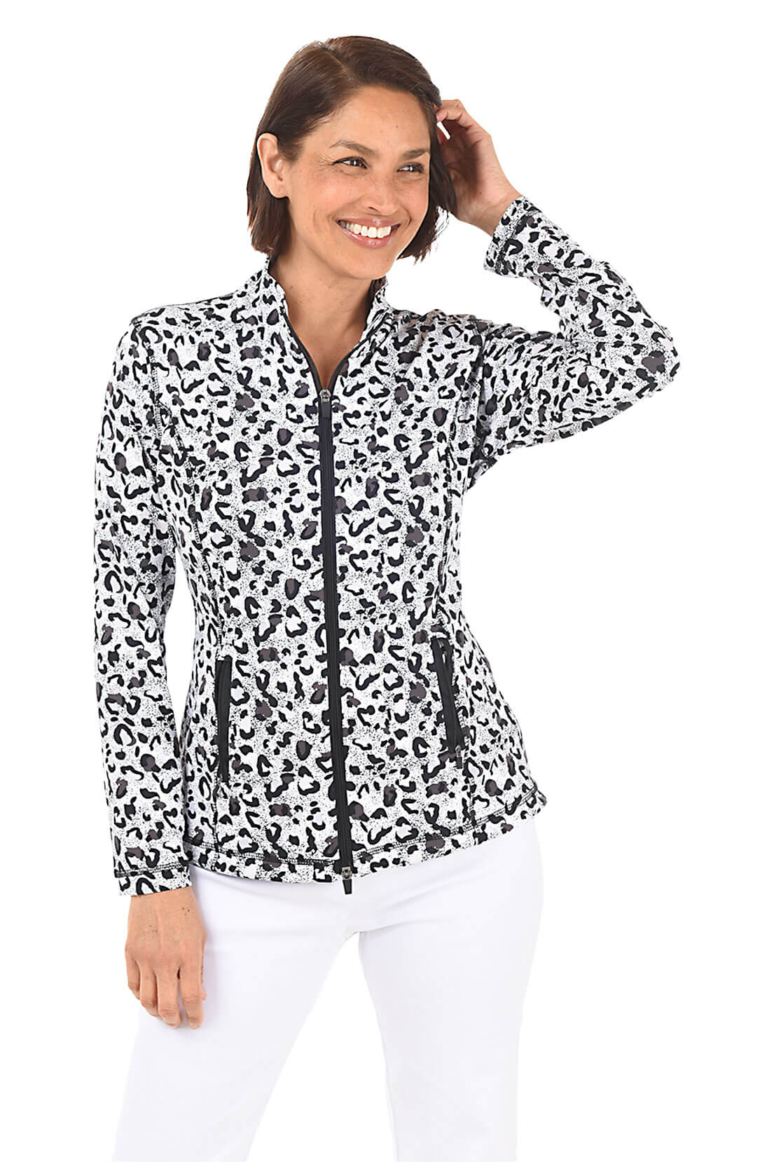 A woman wearing a black and white leopard-spotted zip front jacket and white pants in front of a white background. Alternate front shot.
