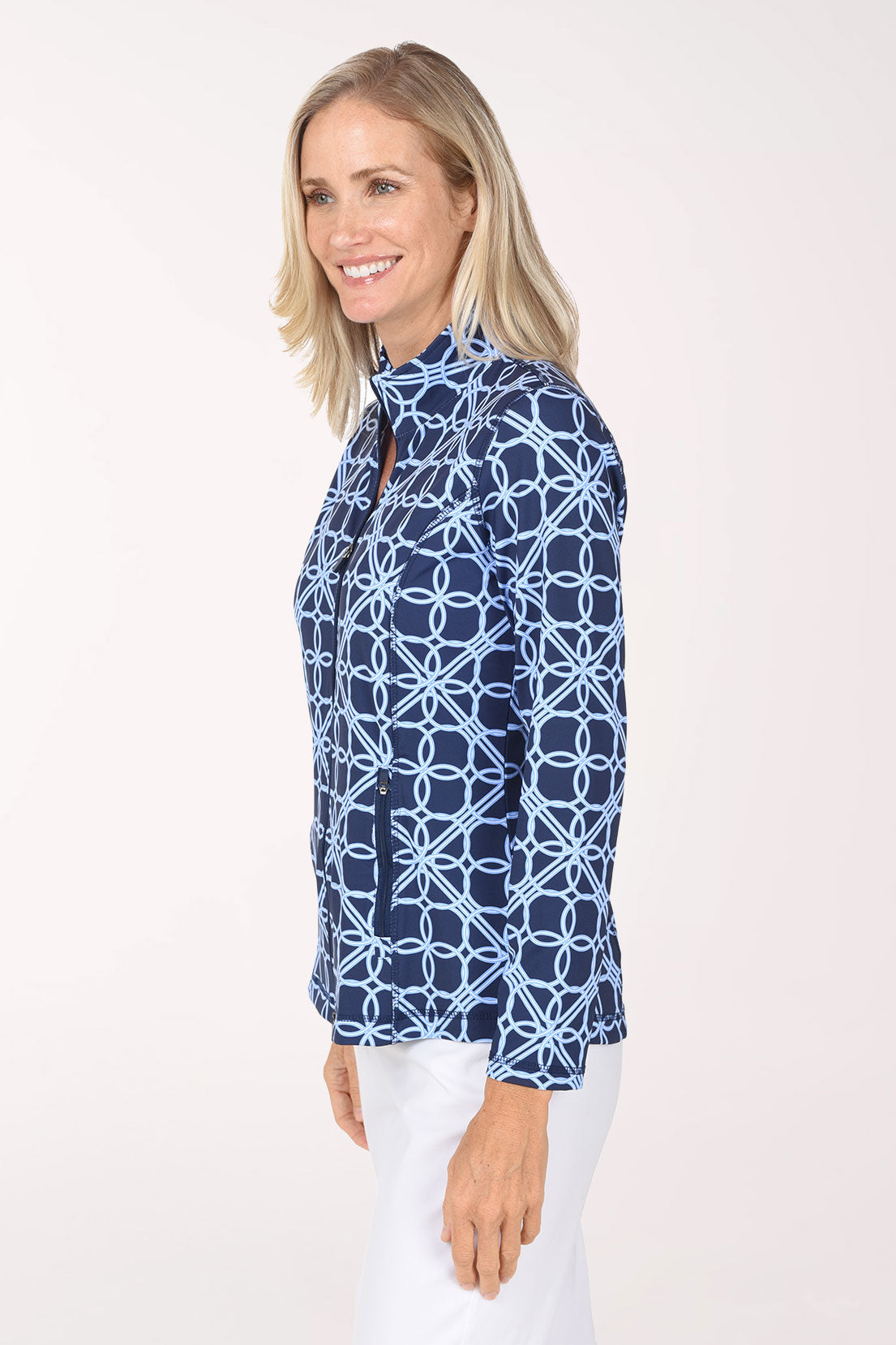 Side view of the Blue Lattice Rings Athletic Zip Jacket showing the long sleeves and curved hem over white pants.