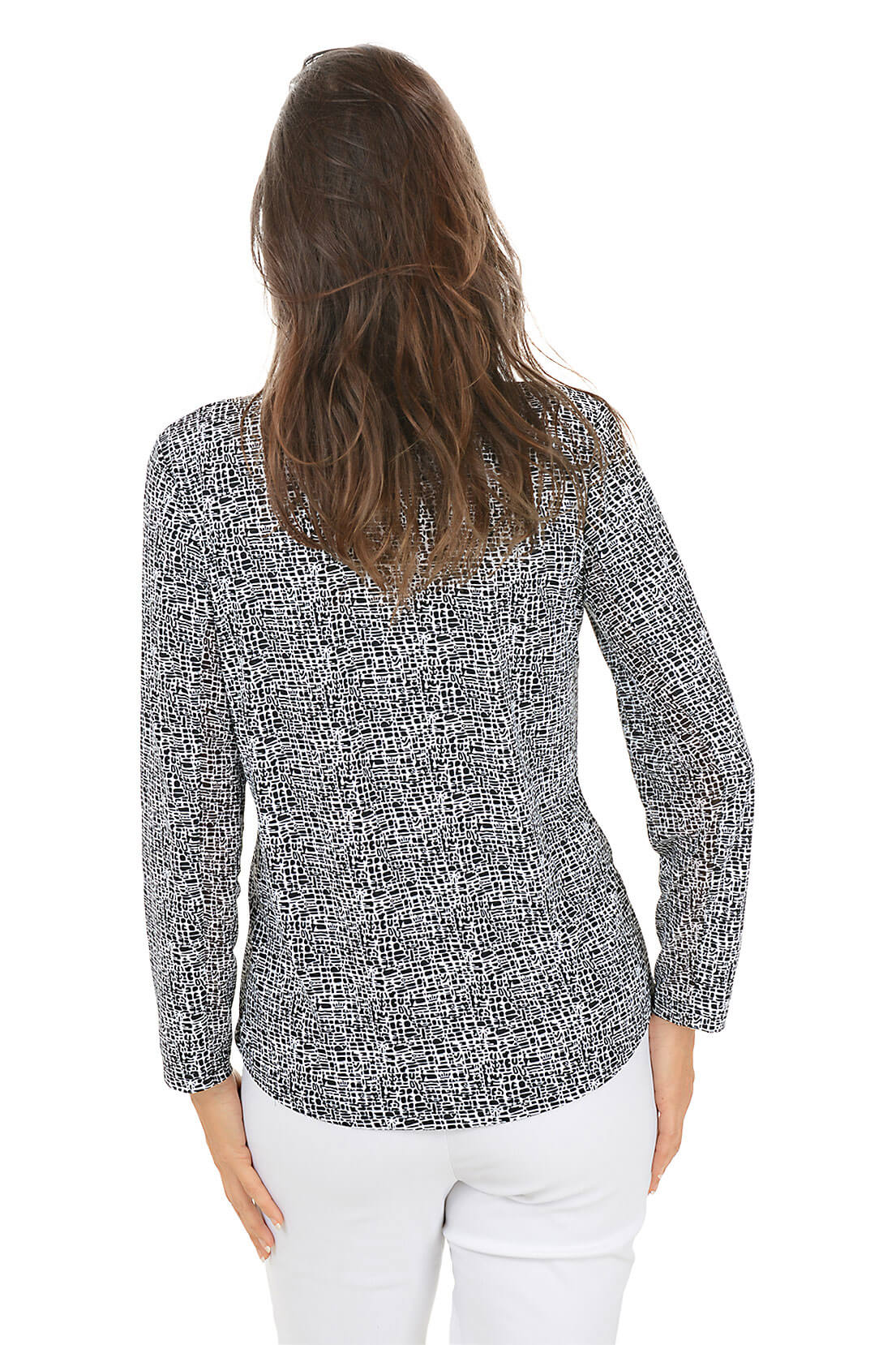 Woman wearing a black and white patterned blouse on a white background