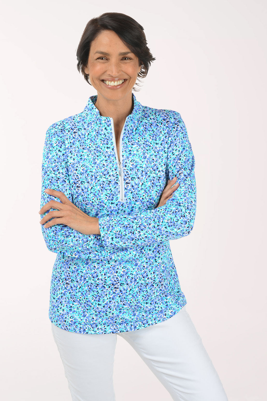 Woman wearing a floral patterned long-sleeve shirt on a white background