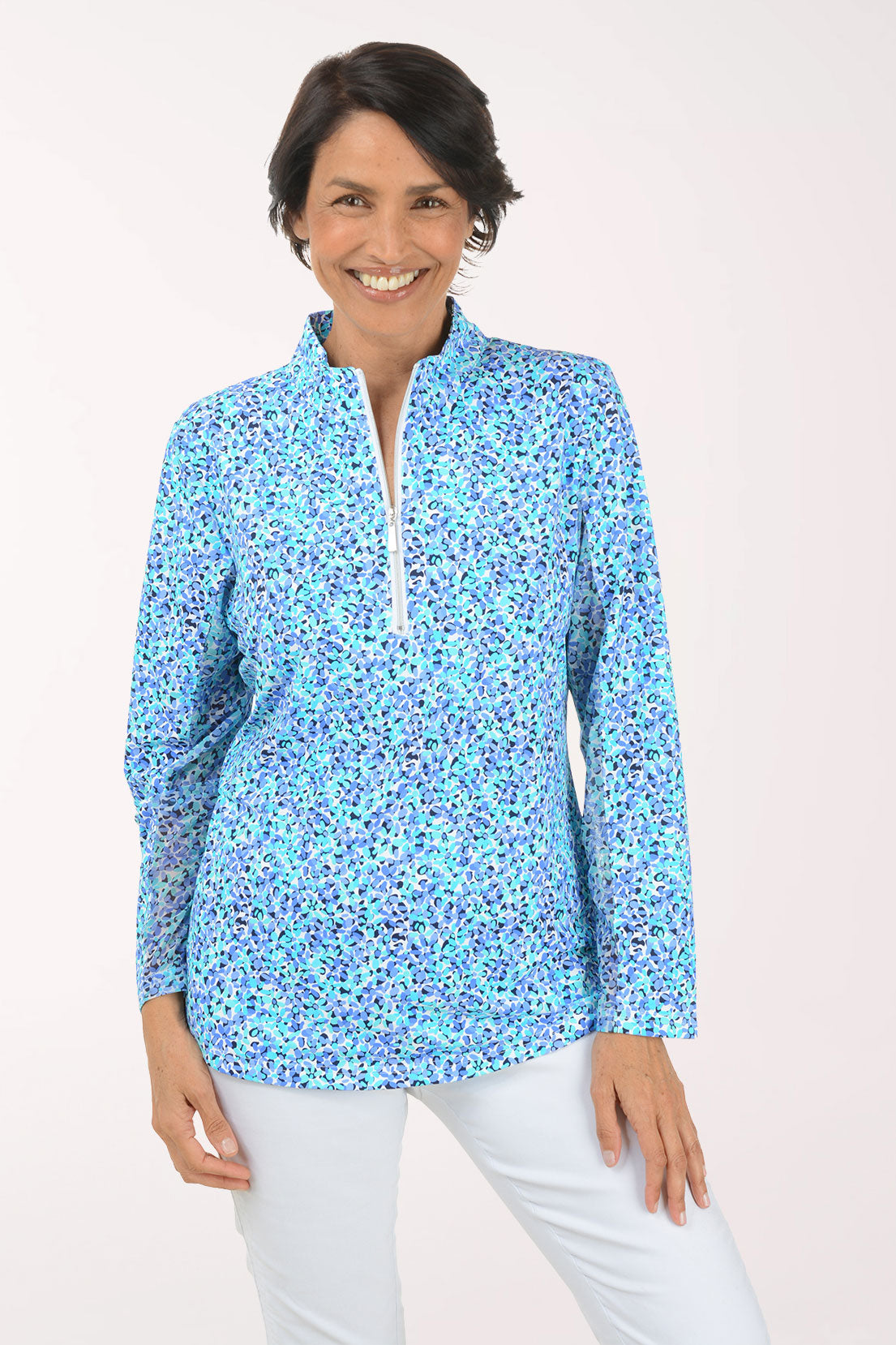 Woman wearing a floral patterned long-sleeve shirt on a white background