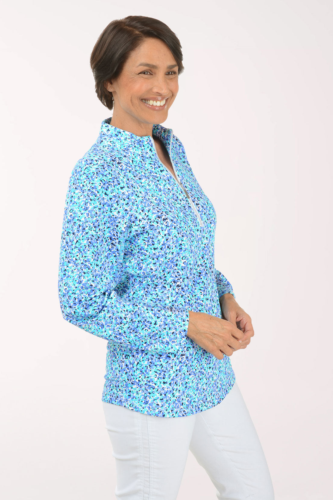 Woman wearing a floral patterned long-sleeve shirt on a white background