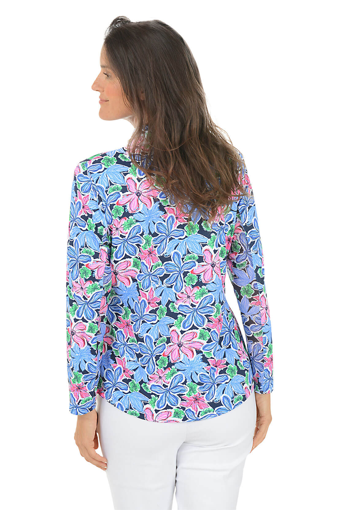 Woman wearing a colorful floral blouse with long sleeves on a white background