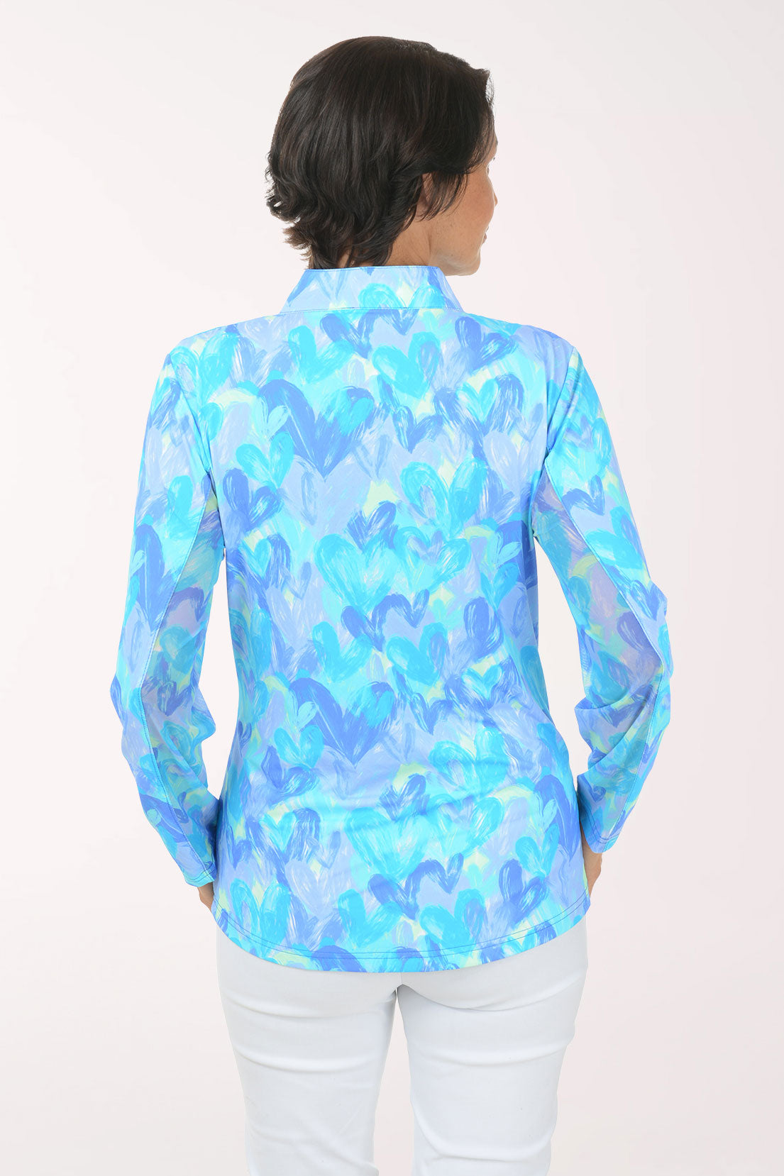 Woman wearing a blue and white patterned shirt on a white background