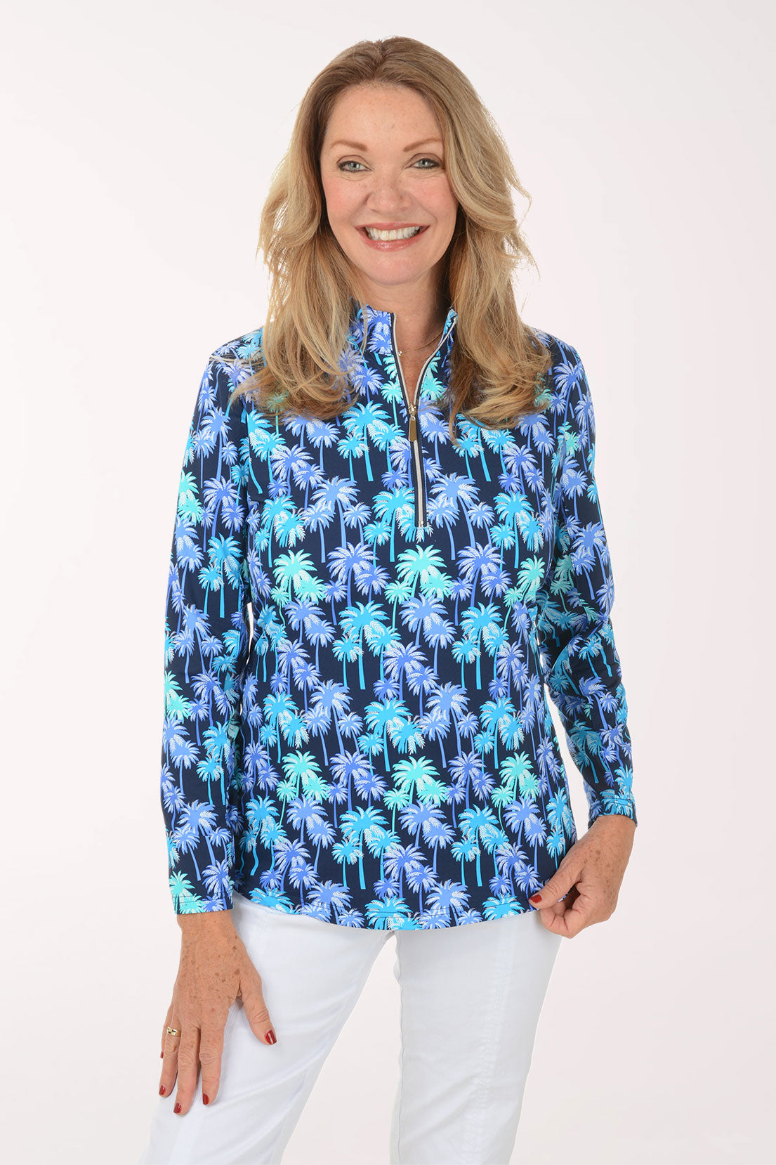 Woman wearing a blue palm tree patterned shirt on a white background