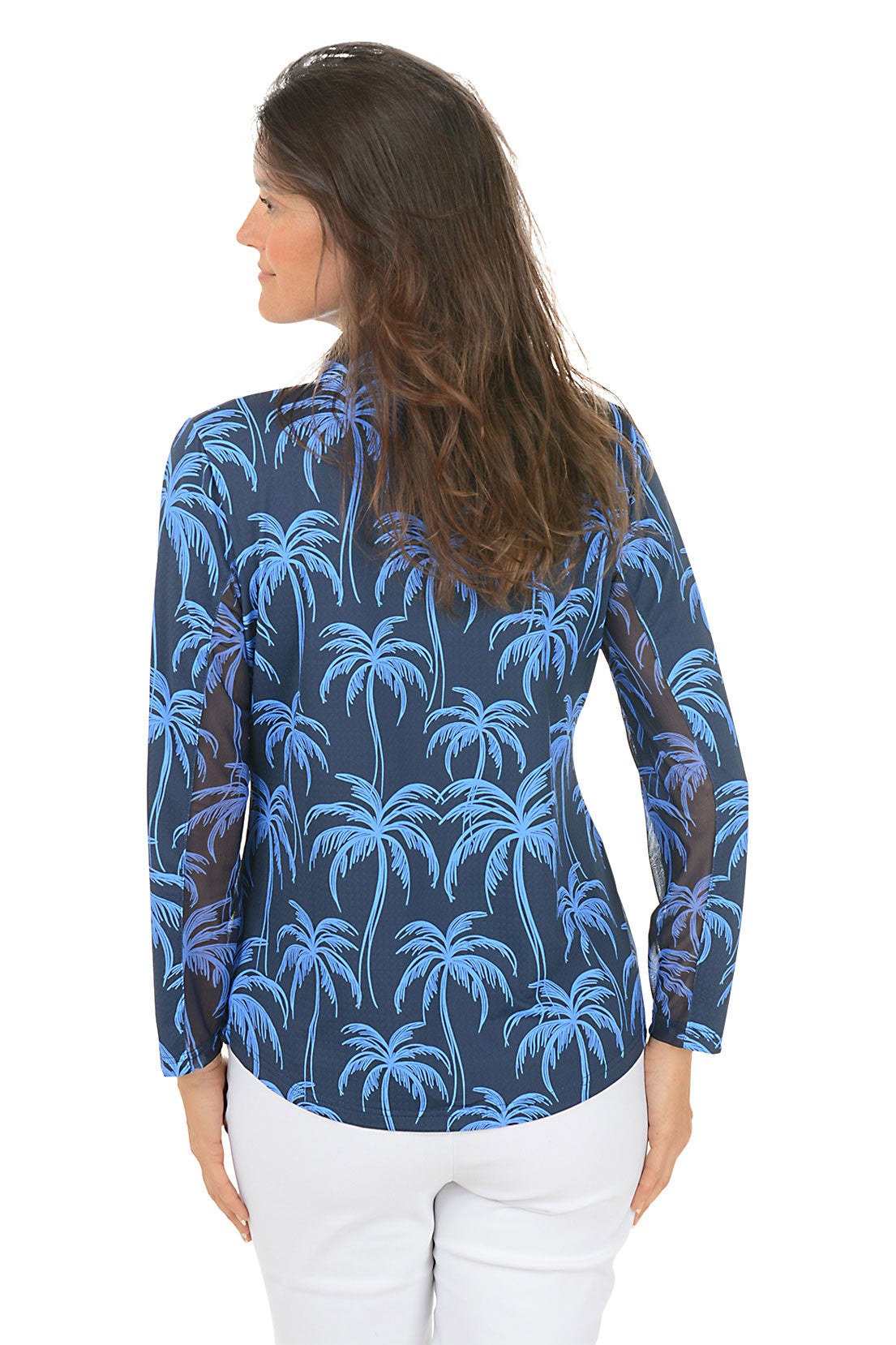 Woman wearing a blue palm tree patterned shirt on a white background. Back shot.