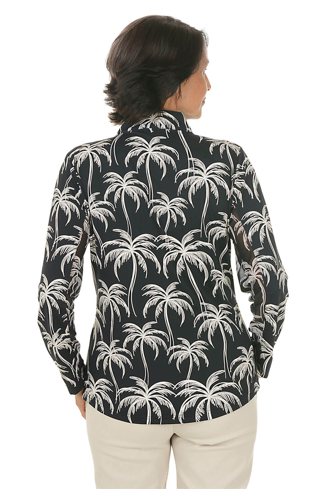 Woman wearing a black shirt with palm tree pattern on a white background