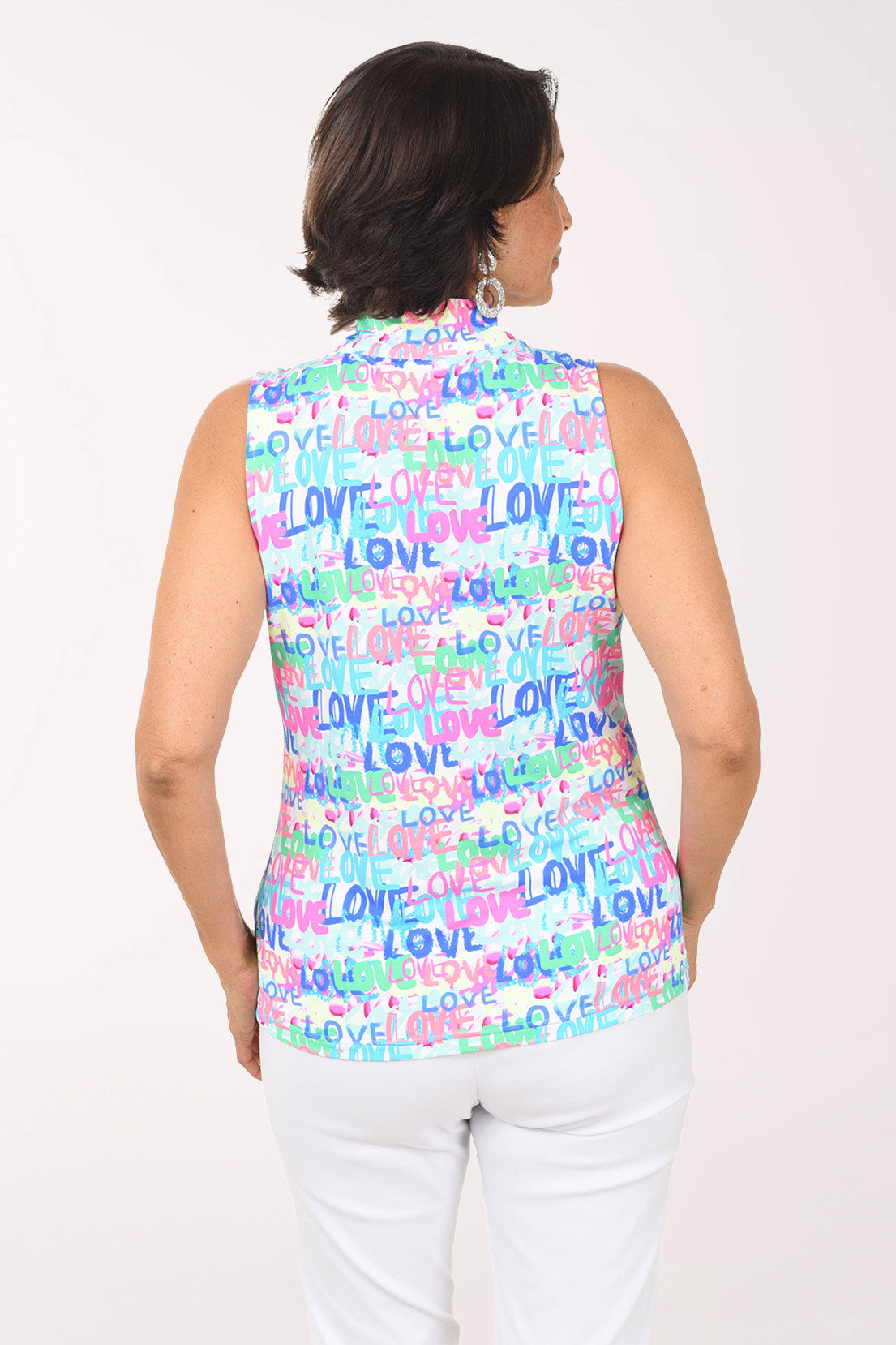 Woman wearing a sleeveless top with 'LOVE' print on a white background