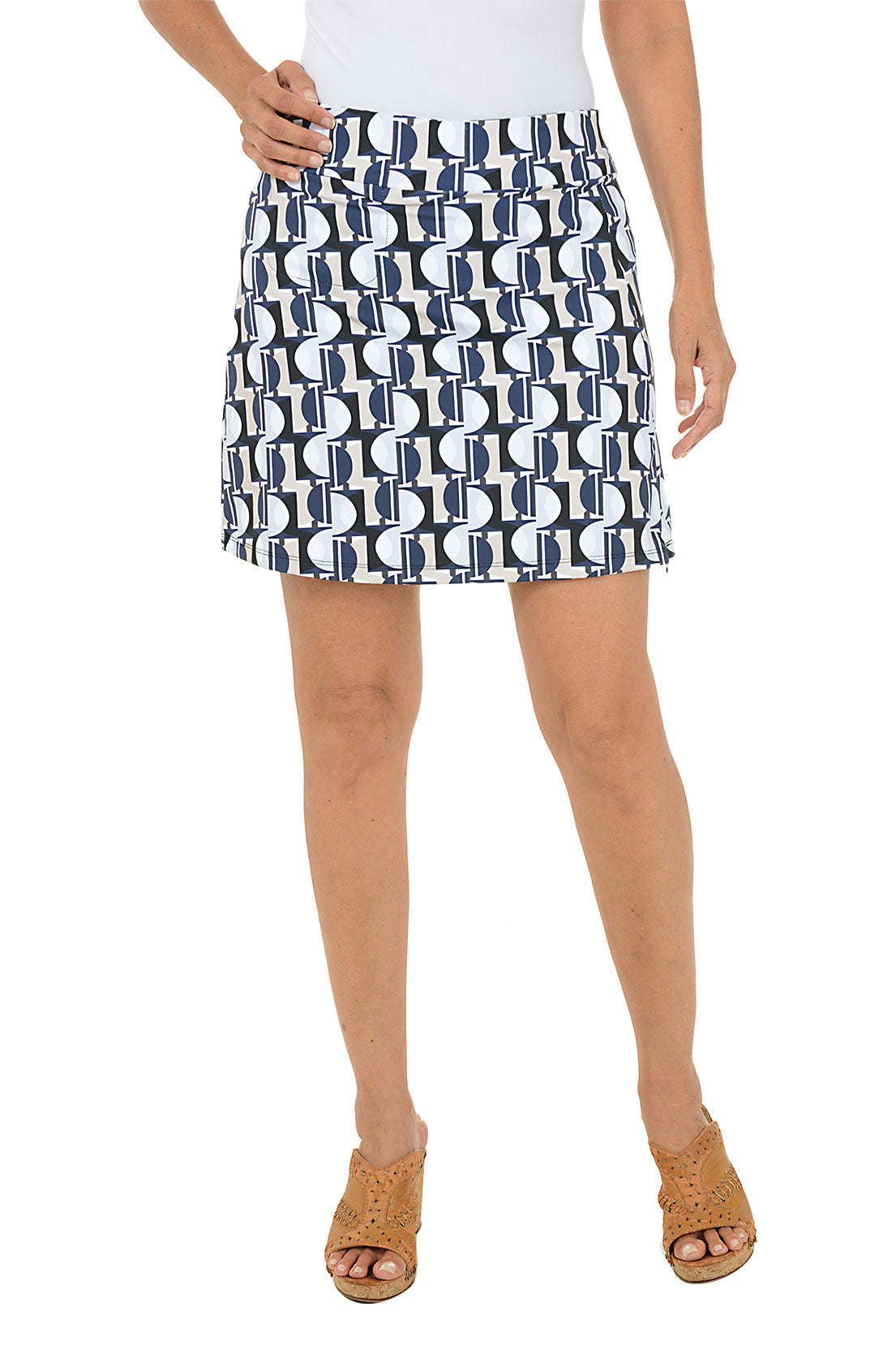 Person wearing a patterned skirt on a white background.