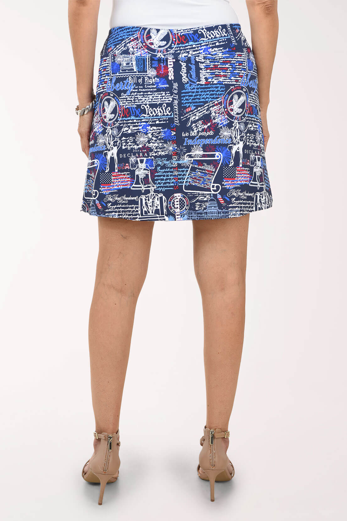 Person wearing a patterned skirt on a white background