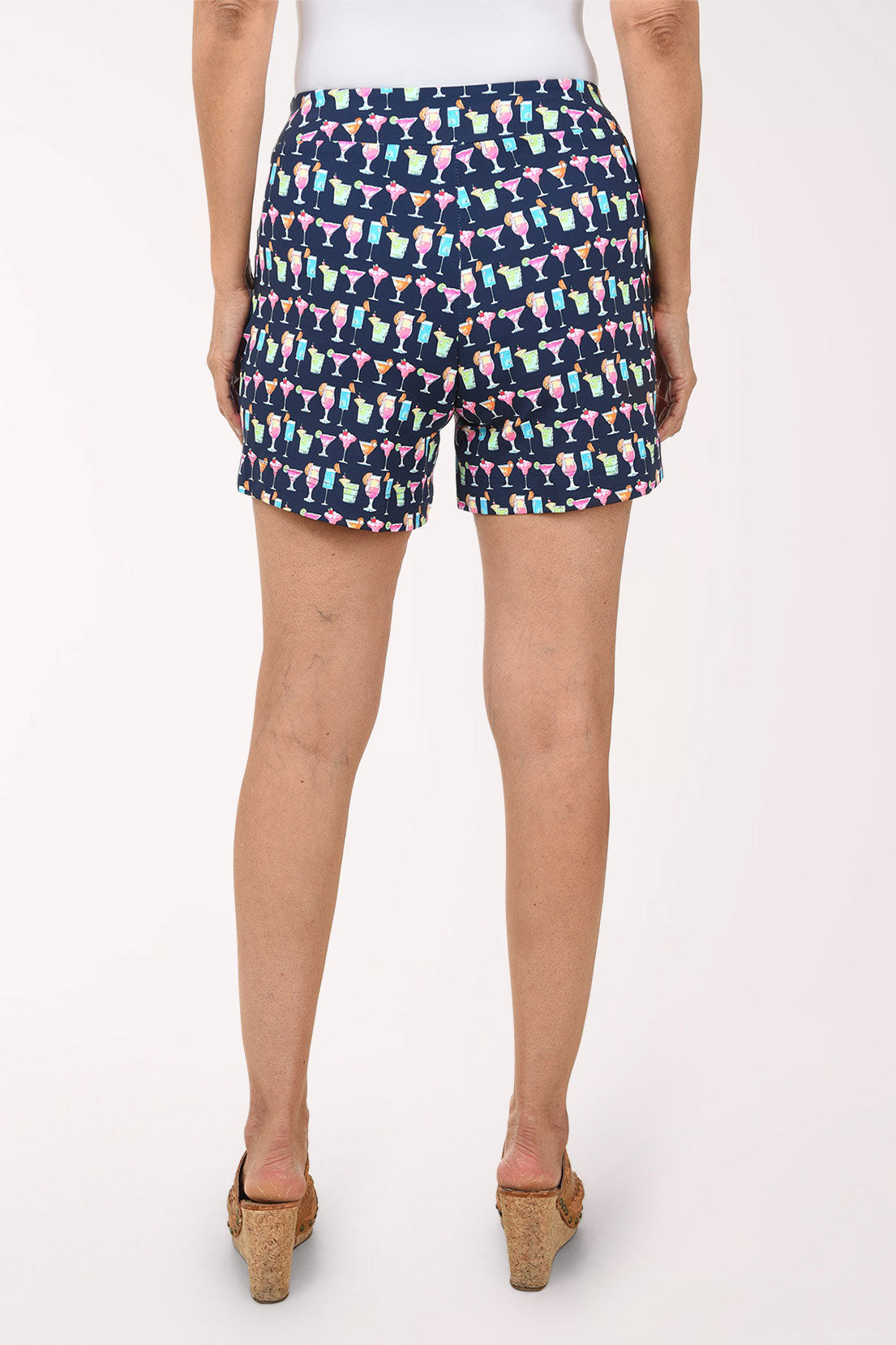 Multicolored patterned shorts worn by a person on a white background