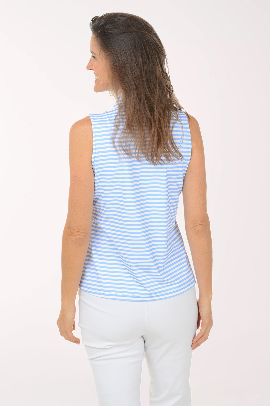 Woman wearing a blue and white striped sleeveless top against a white background