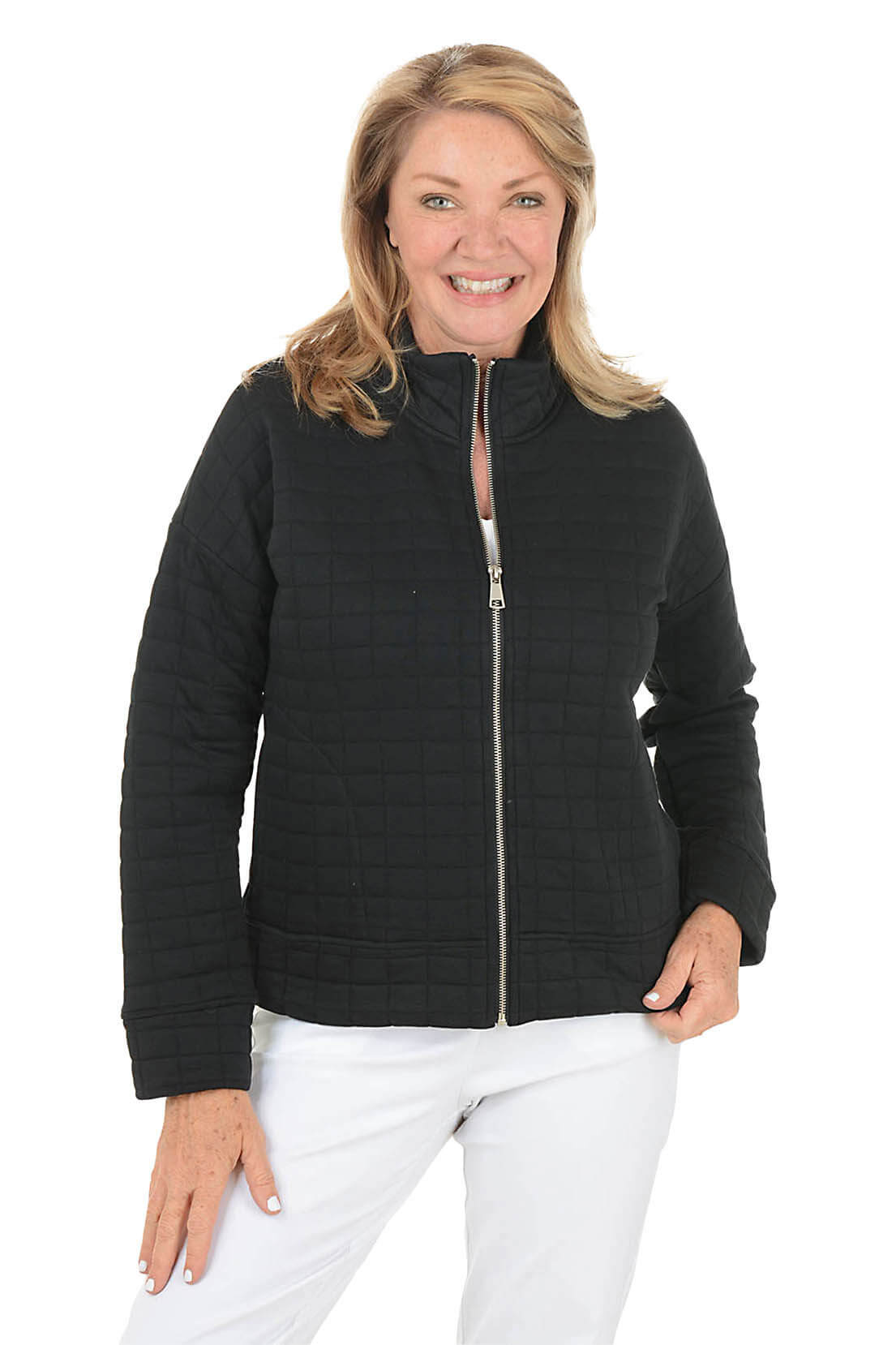 Woman wearing a black quilted jacket on a white background