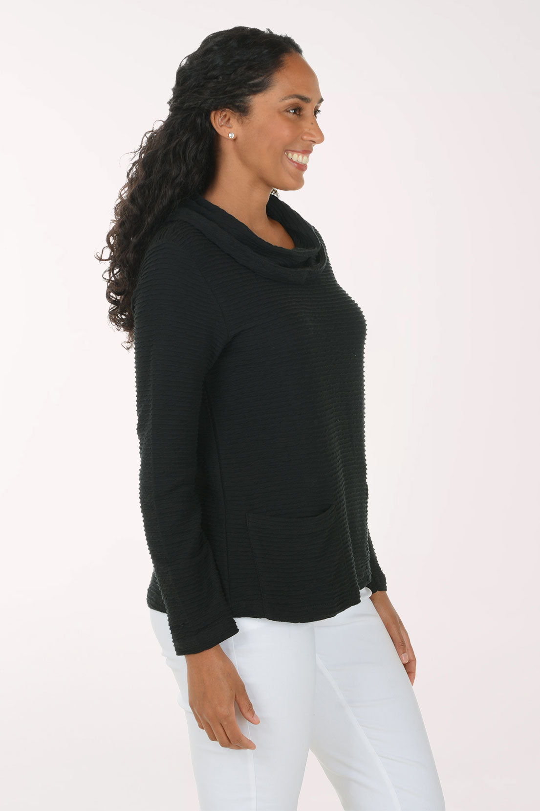 Woman wearing a solid black cowl neck long sleeve top