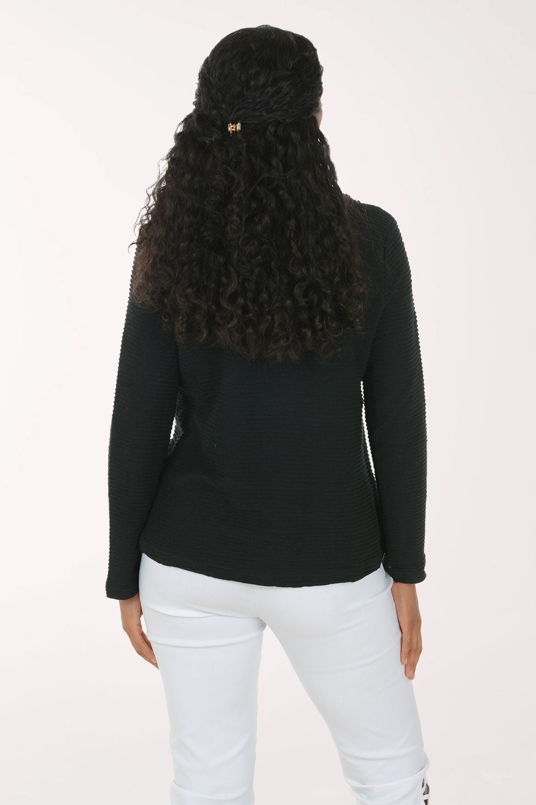 Woman wearing a solid black cowl neck long sleeve top