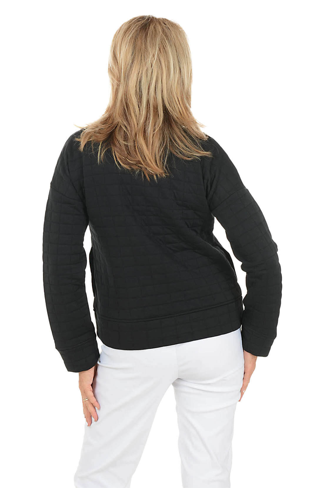 Woman wearing a black quilted jacket on a white background. Back shot.