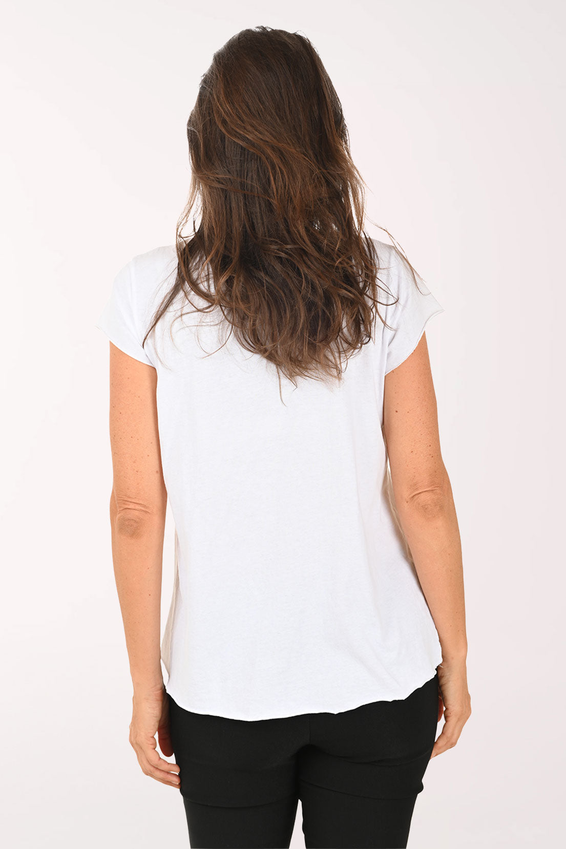 Woman wearing a white t-shirt with a colorful dog graphic and 'Bee Happy' text on a plain background