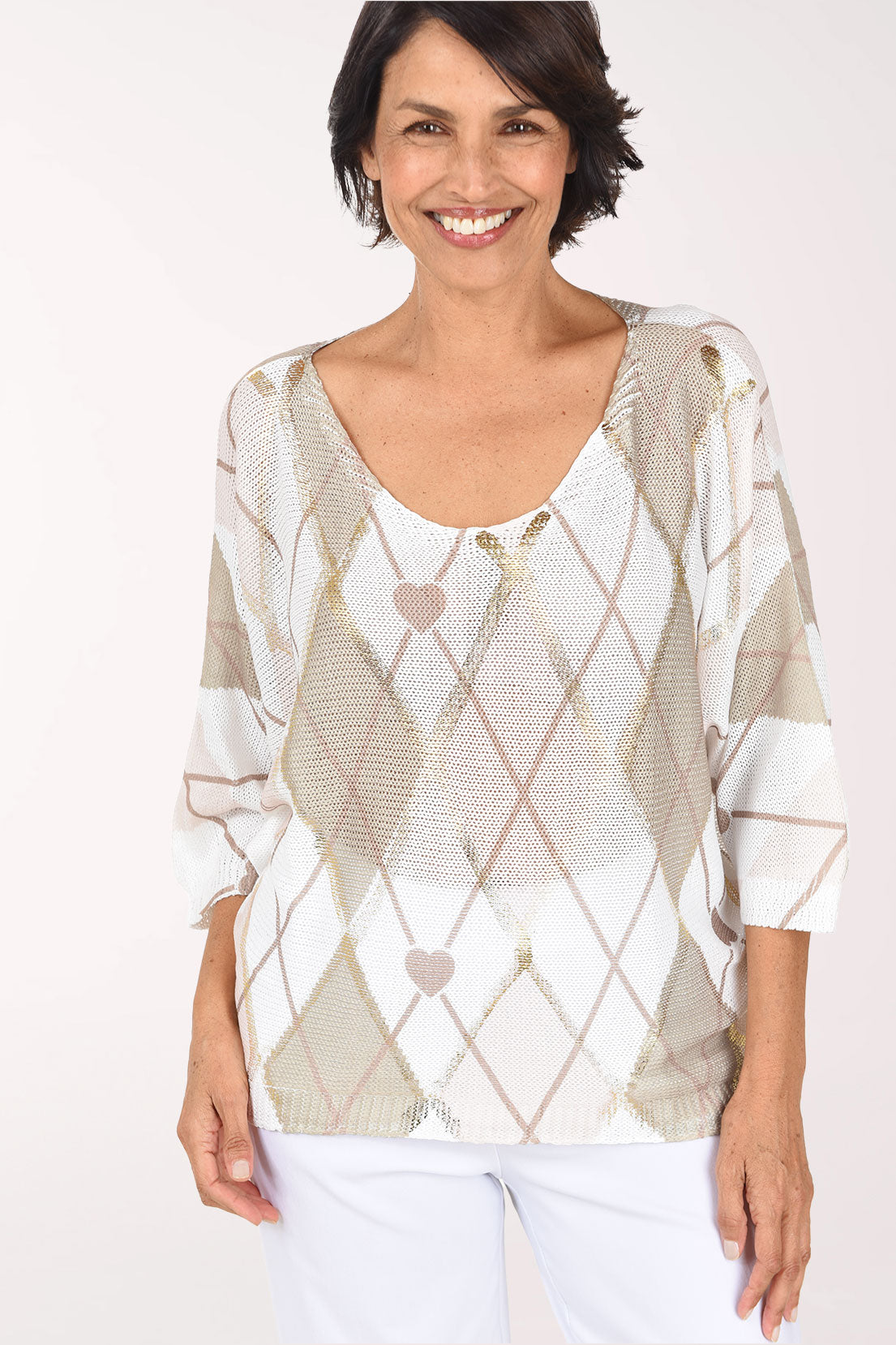 Front view of the beige argyle sweater, showing diamonds outlined in thin taupe lines, small heart motifs and a relaxed fit