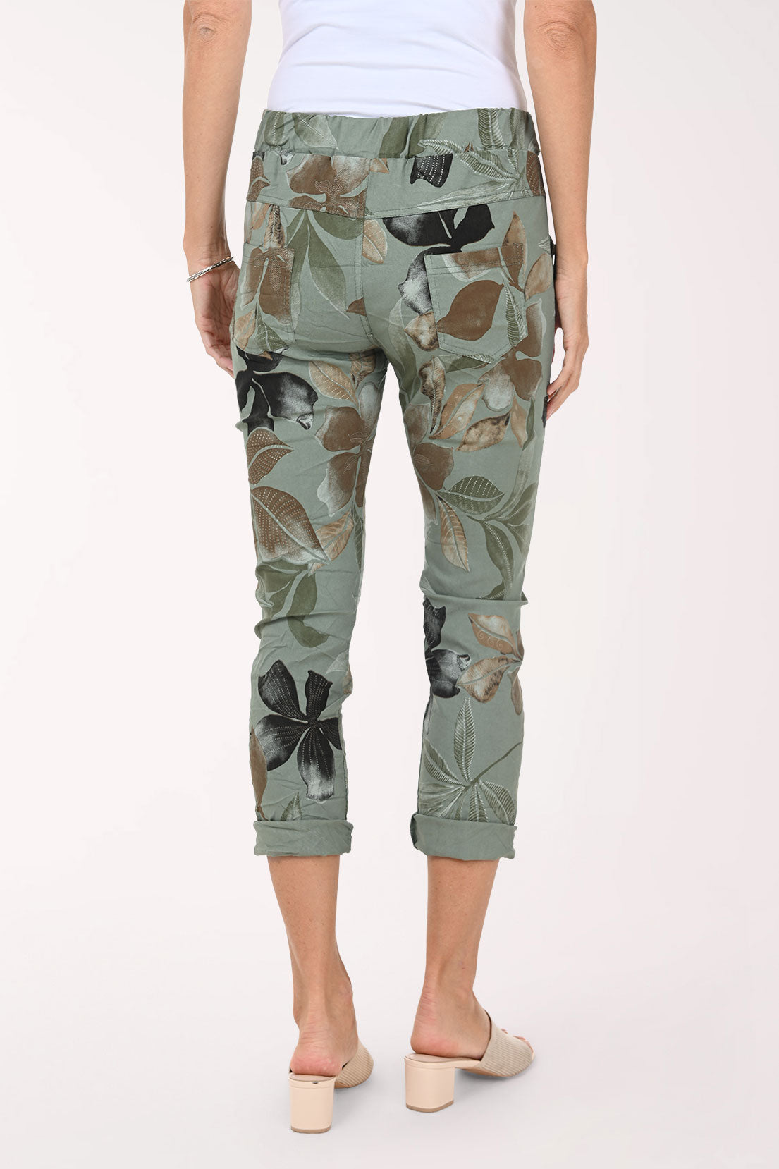 Person wearing green camouflage pants on a white background
