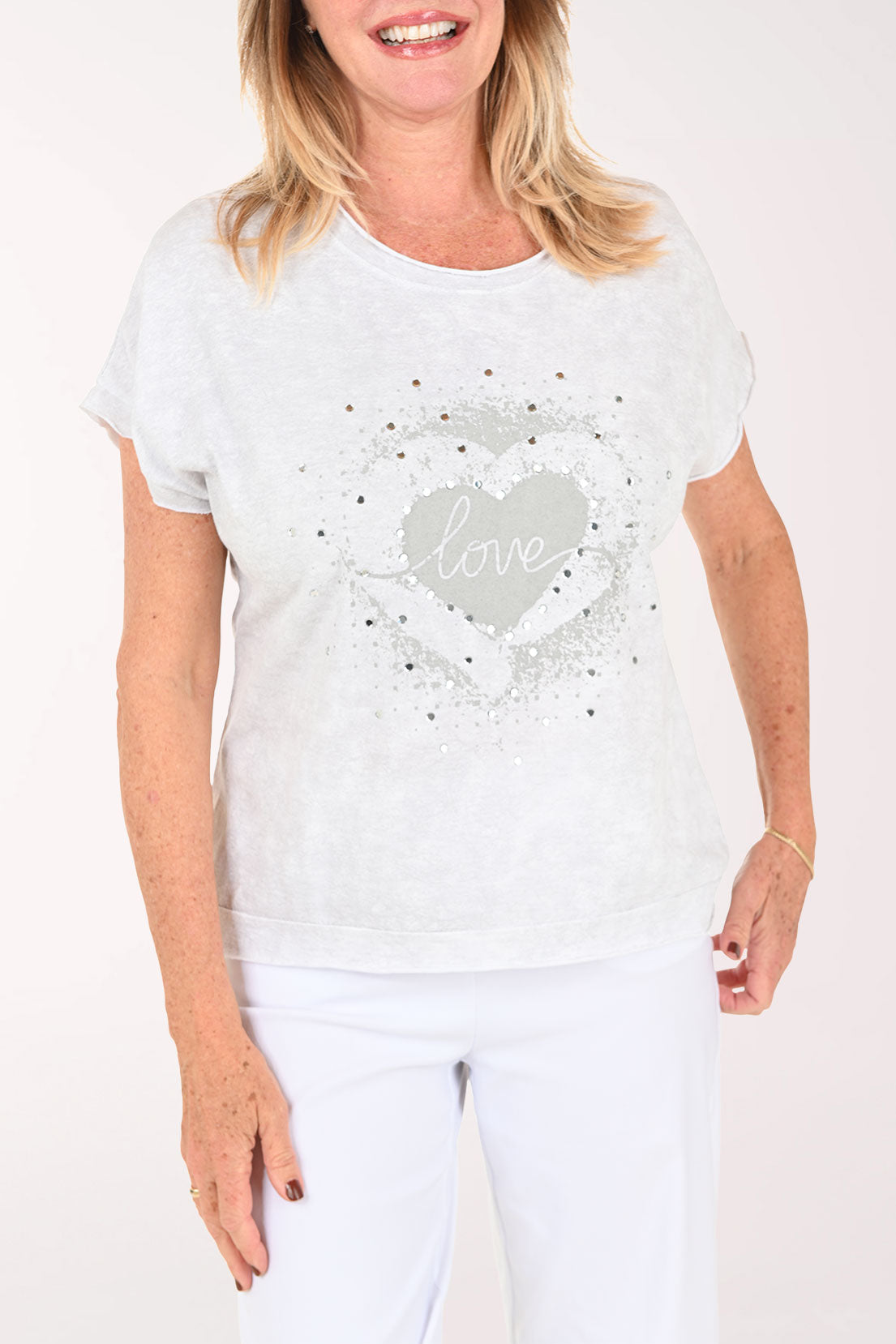 Woman wearing a short sleeve grey tee with the word 'love' on it