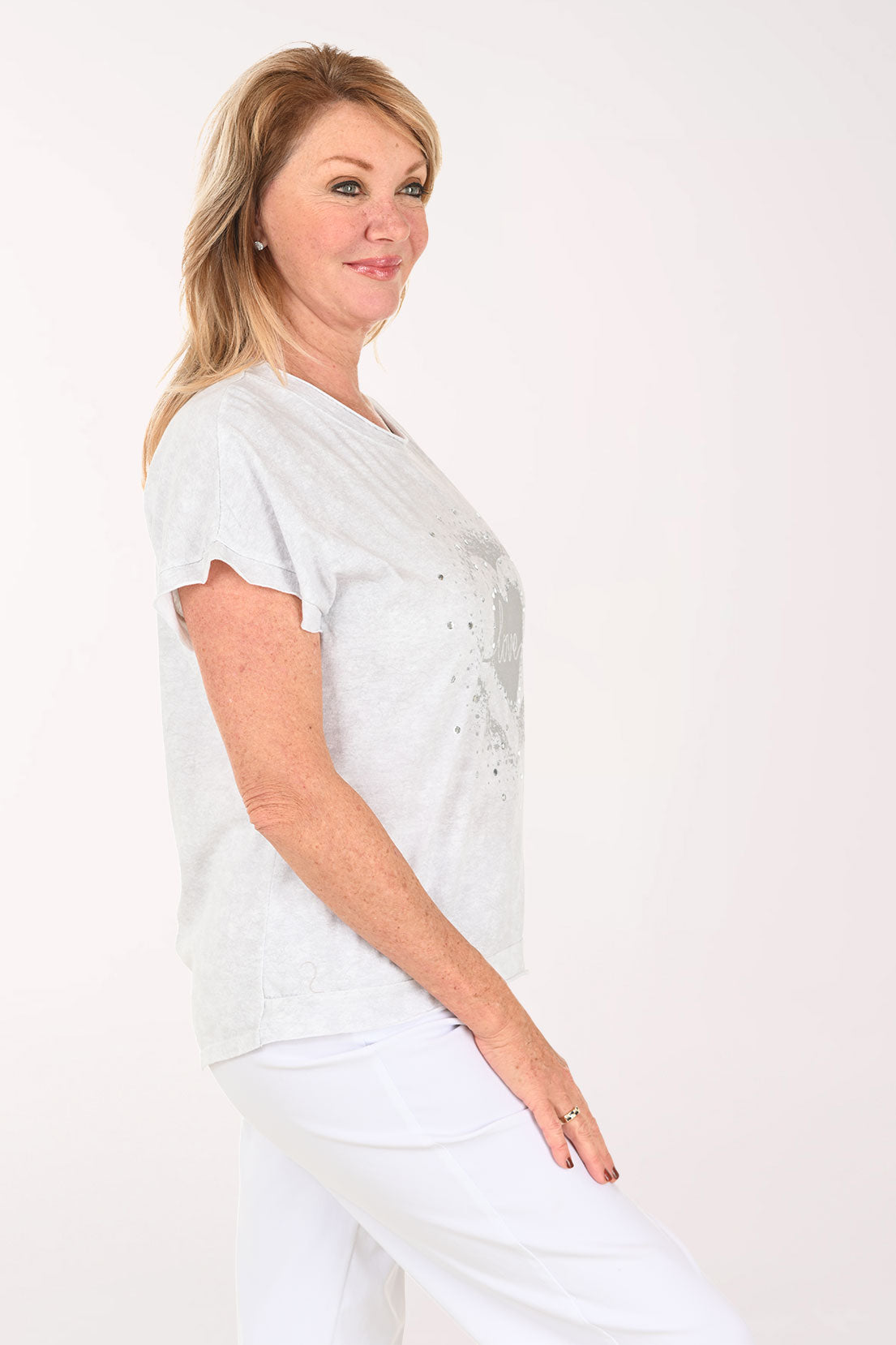Woman wearing a short sleeve grey tee with the word 'love' on it