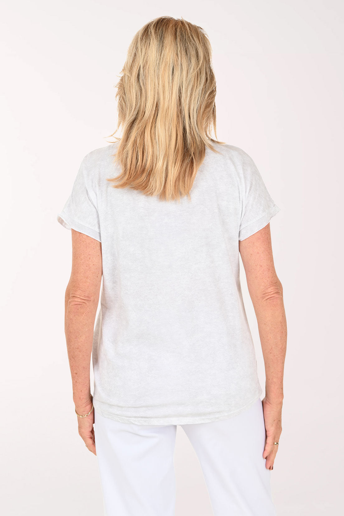 Woman wearing a short sleeve grey tee with the word 'love' on it