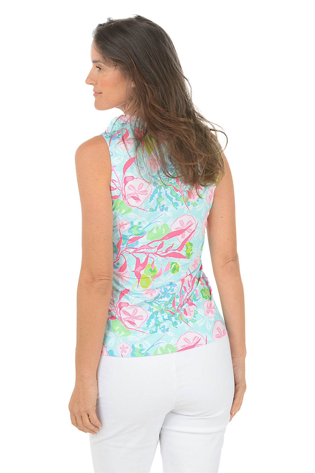 Woman wearing a colorful floral sleeveless top on a white background
