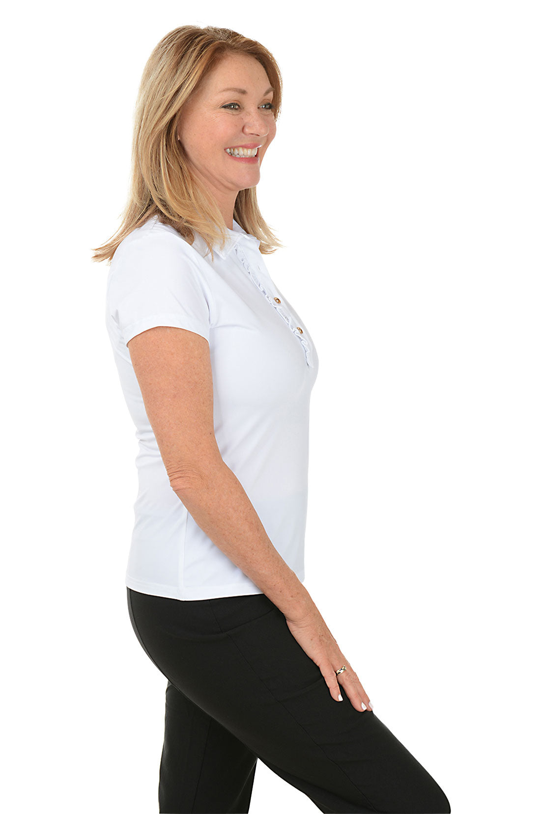 A woman wearing a white short sleeve polo top with a foldover collar and buttoned half placket, paired with black pants. Side shot.