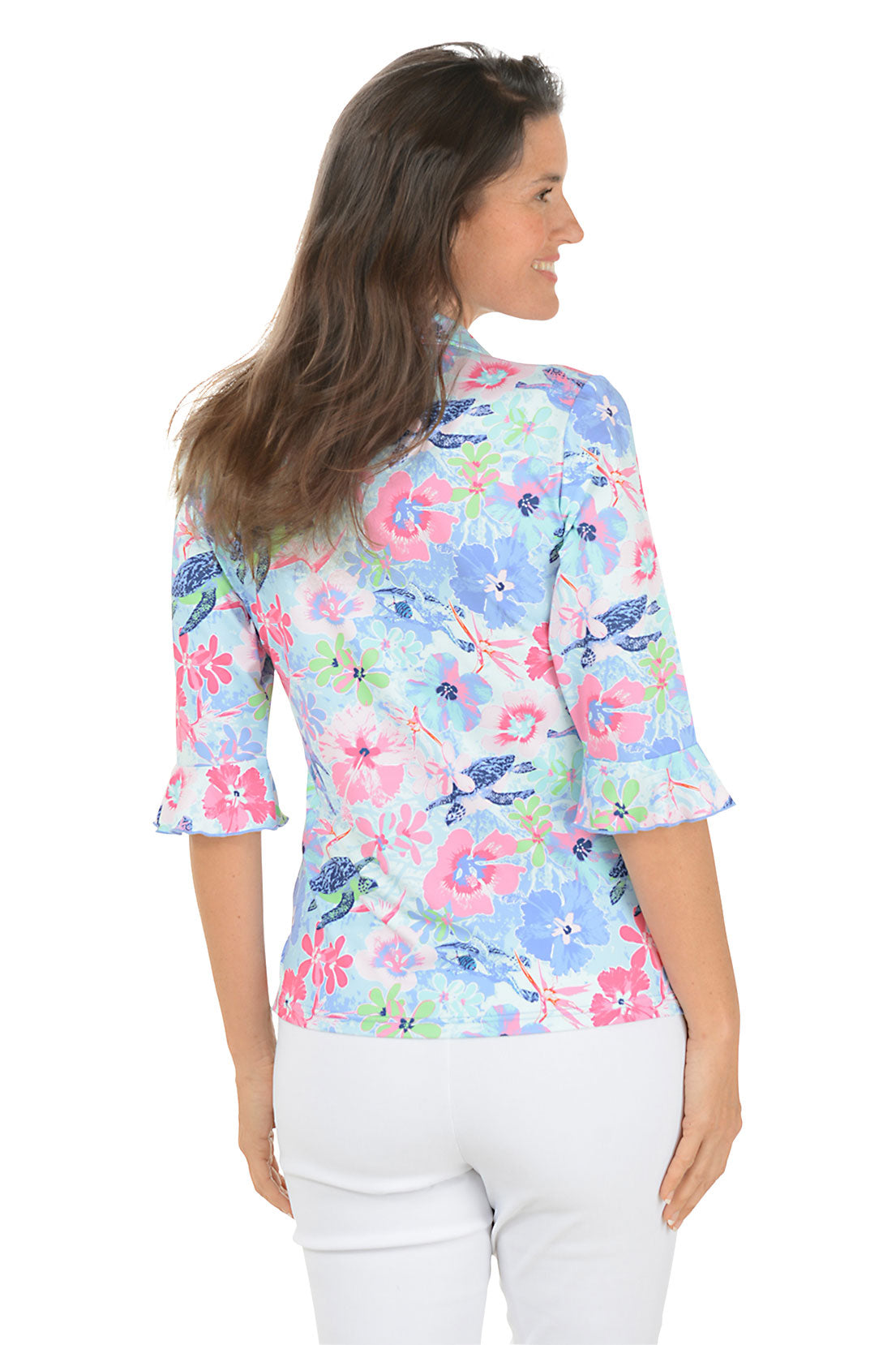 Woman wearing a colorful floral shirt with a white background
