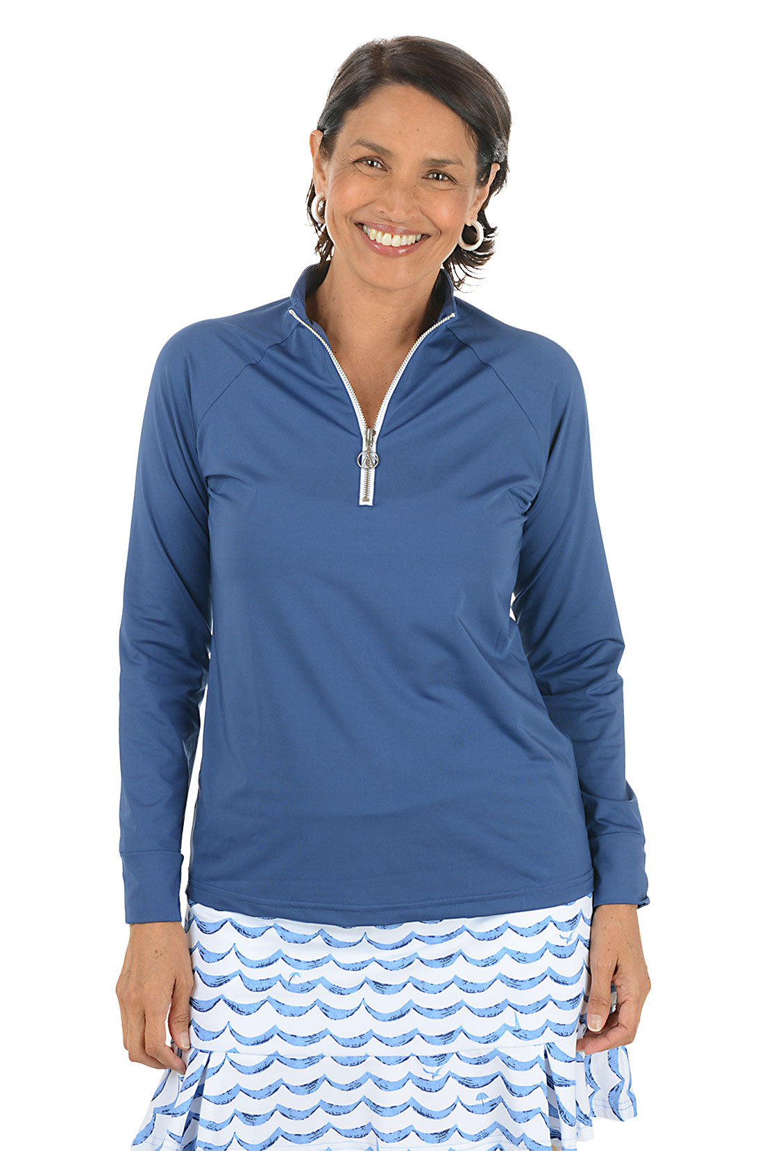 Woman wearing a blue long-sleeve top with a zipper, standing against a white background.