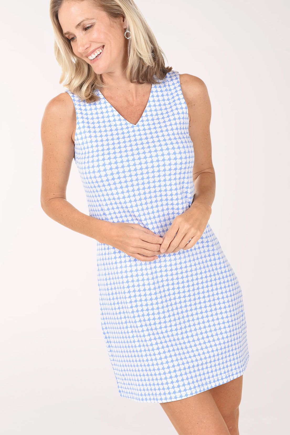 Woman wearing a light blue checkered dress on a white background