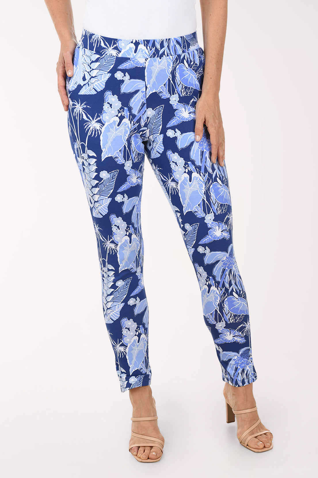 Blue floral pants worn by a person on a white background