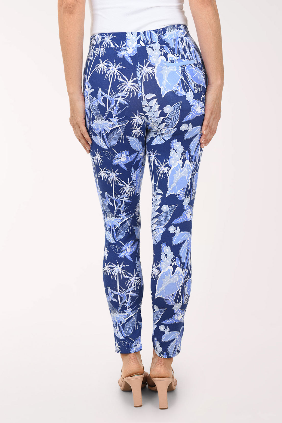 Blue floral pants worn by a person on a white background