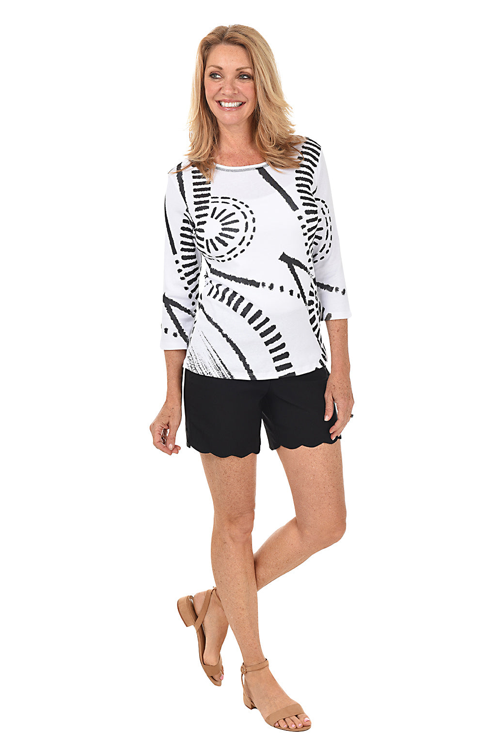 A model wearing black pull-on stretch scallop shorts with small front pockets and a flat back design. Full length front shot.