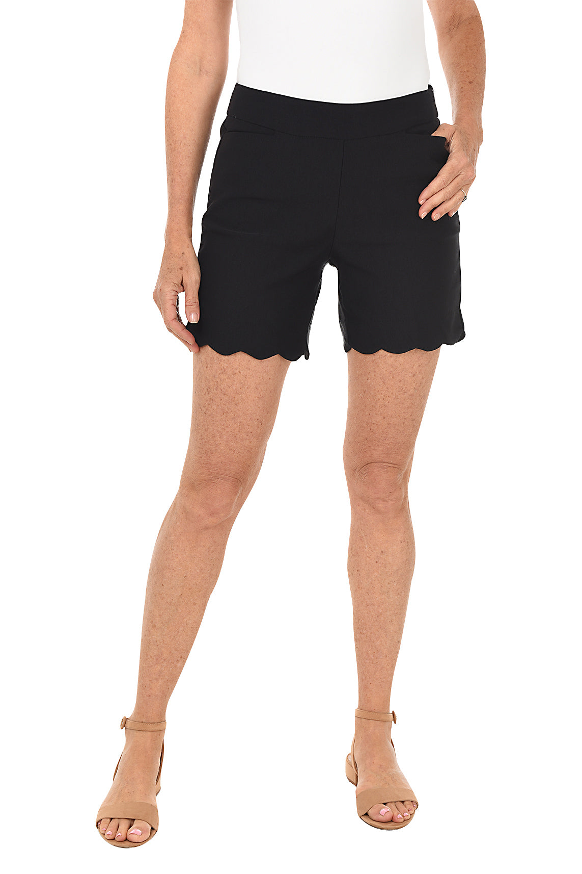 Black shorts with scalloped hem worn by a person on a white background