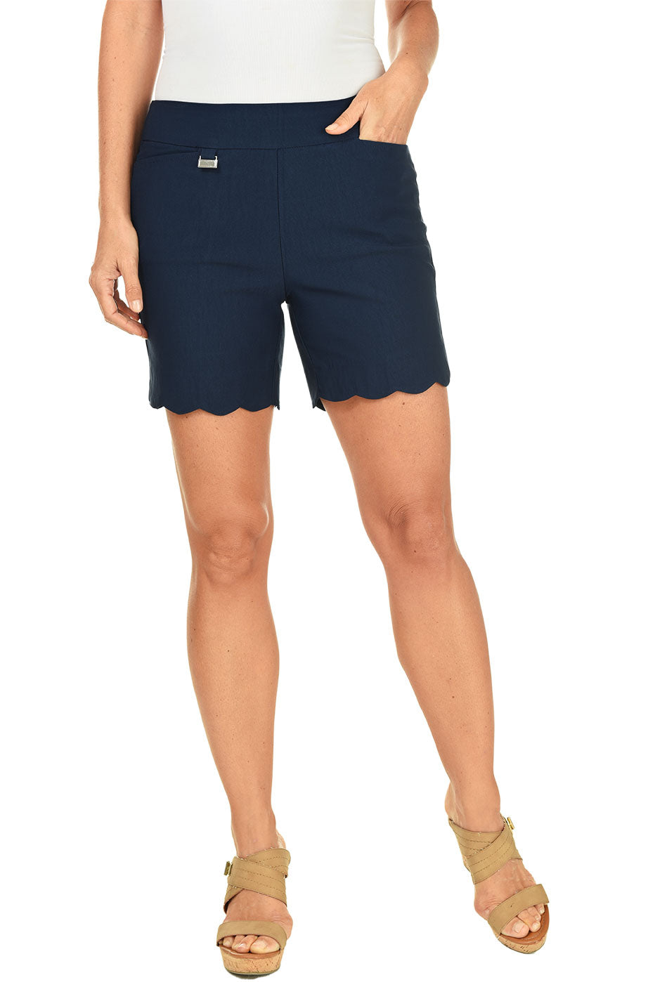 A model wearing navy pull-on stretch scallop shorts with small front pockets and a flat back design.
