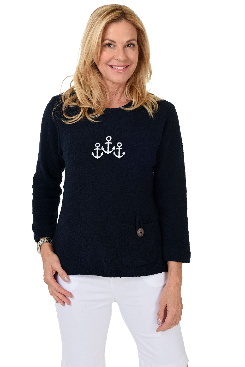 Woman wearing a navy sweater with anchor design on a white background