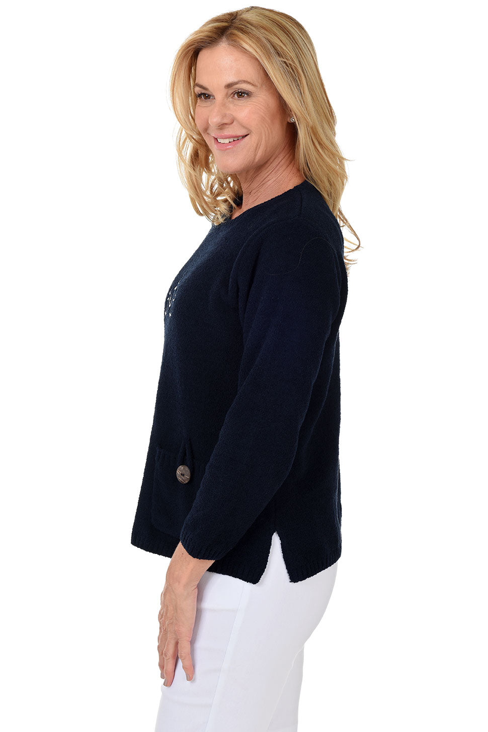 Side shot of woman wearing a navy blue cardigan with a white background