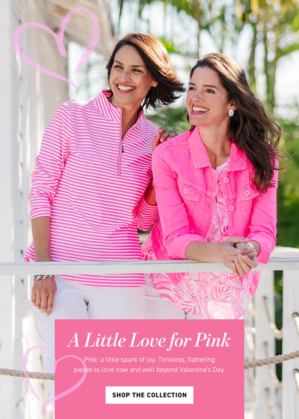 Two women in pink clothing standing next to a railing with a promotional banner for 'A Little Love for Pink'.