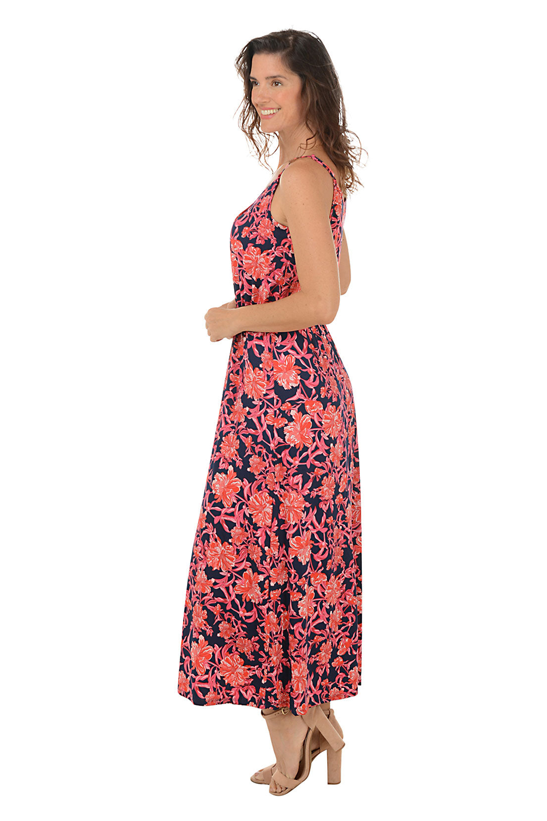 A sleeveless maxi dress with a floral pattern, featuring a scoop neckline, adjustable straps, and a straight hemline. The dress is worn by a model posing against a white background. Side shot.