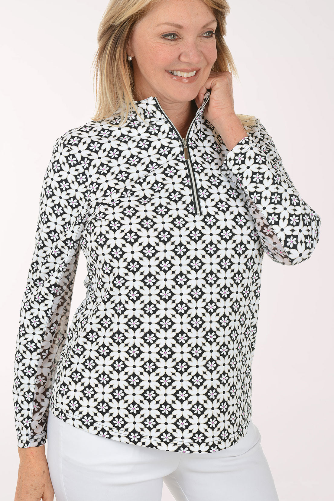 Woman wearing a black and white patterned long-sleeve shirt on a white background