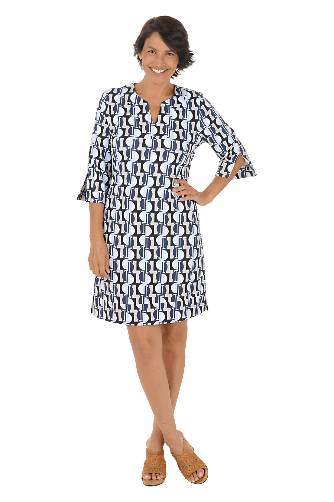 Woman wearing a patterned dress on a white background.