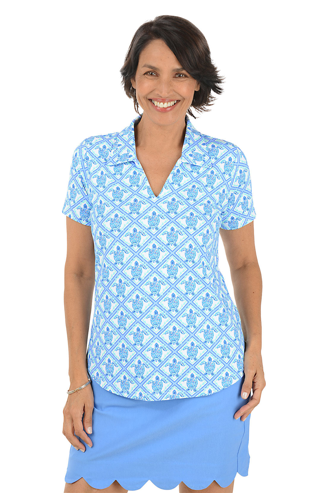 Woman wearing a blue patterned top and skirt on a white background.