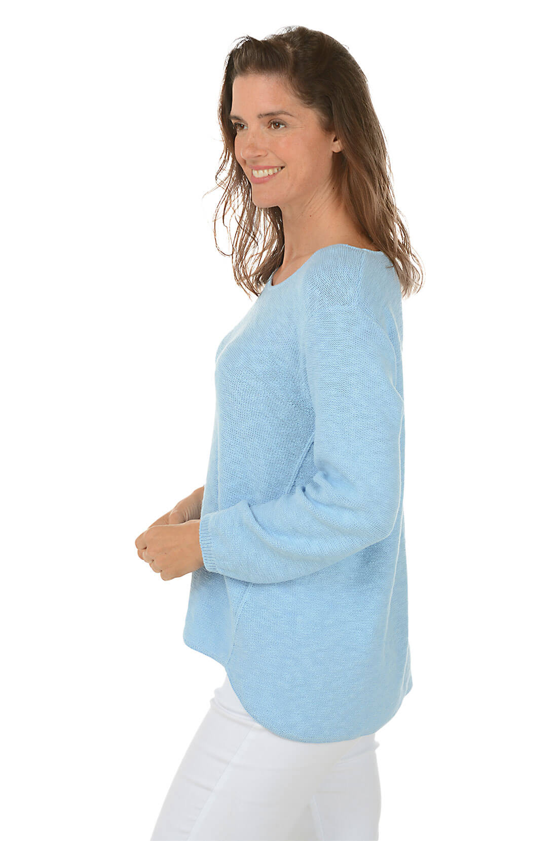 Woman wearing a light blue sweater on a white background