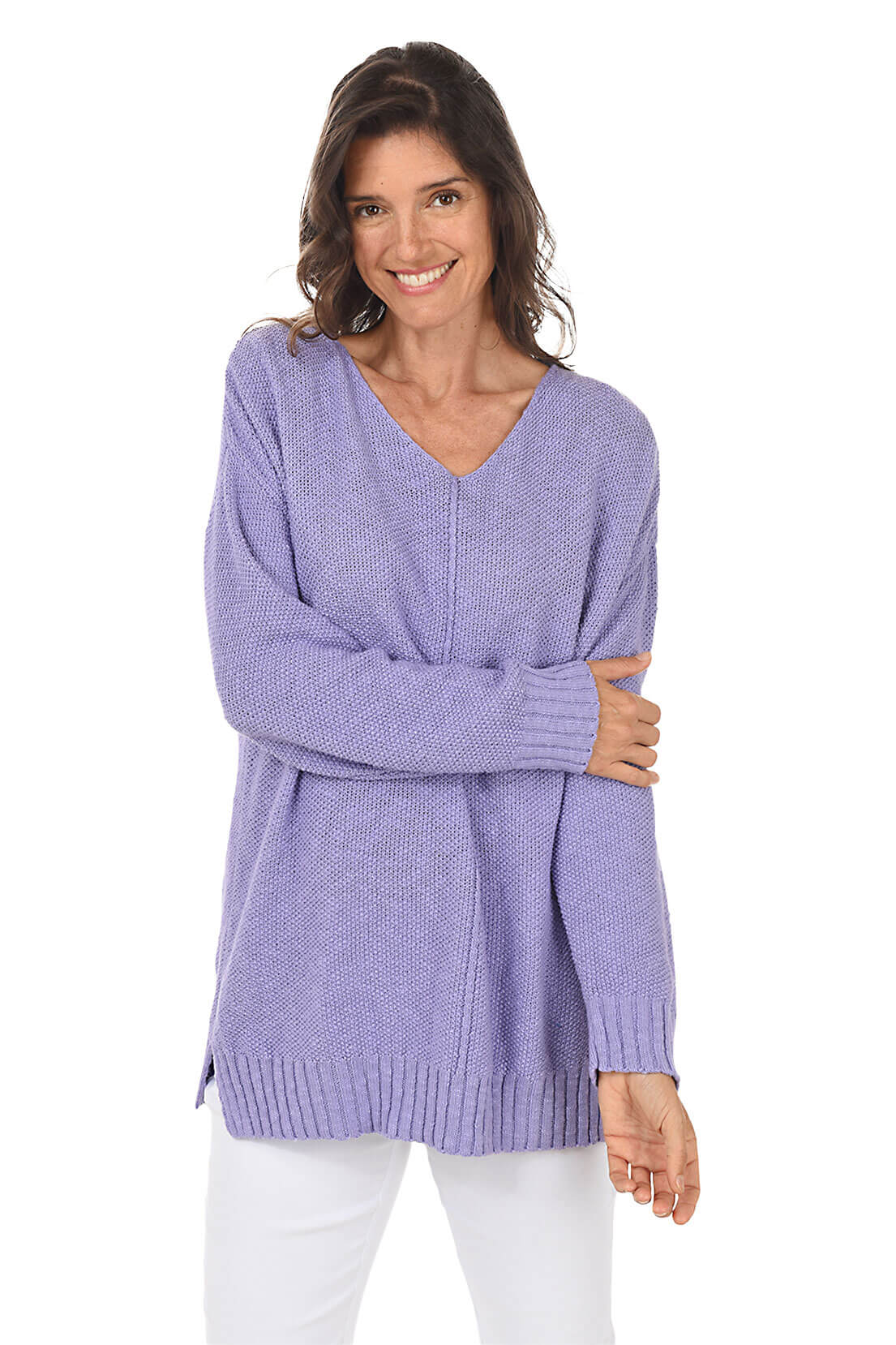 A woman wearing a long sleeve lavender cotton V-neck sweater, with a seam down the front and white pants.