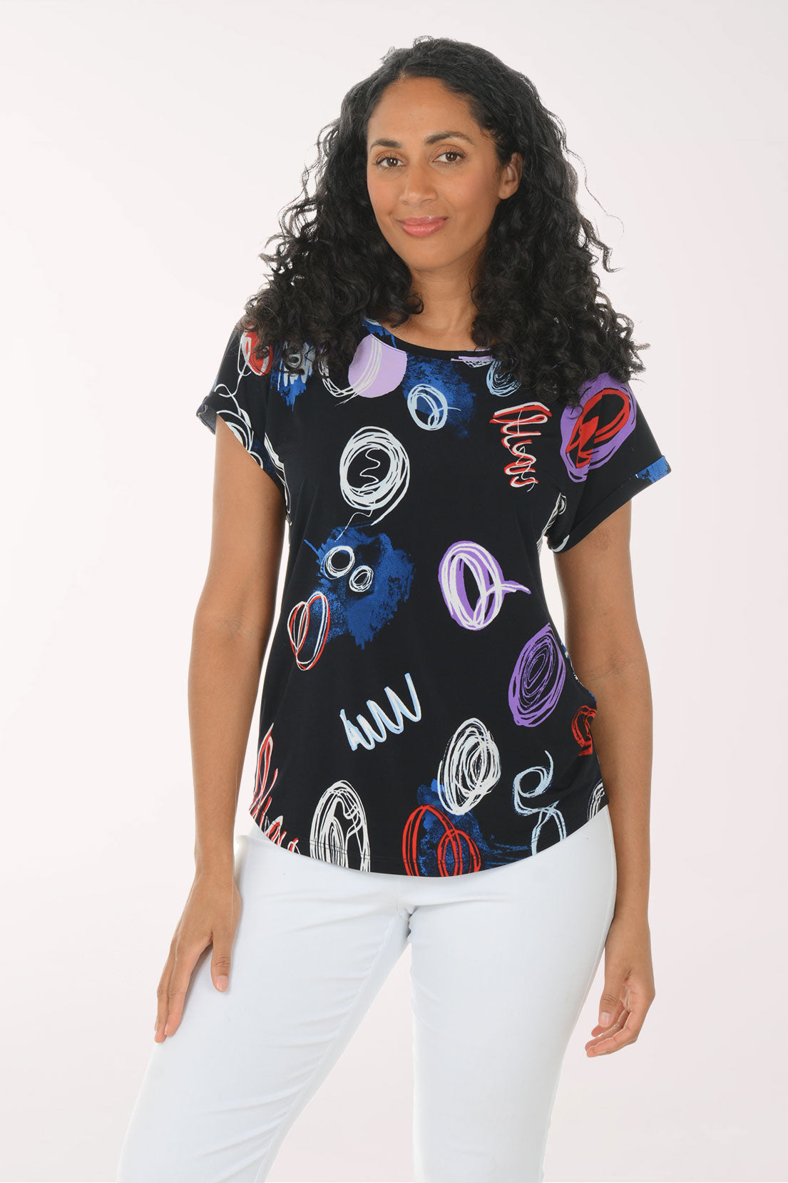 Woman wearing a black t-shirt with colorful abstract designs on a white background