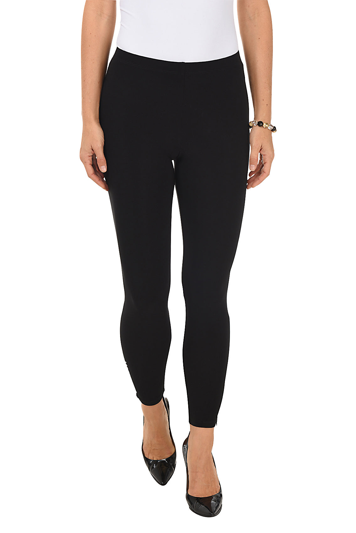 A model wearing black pull-on legging pants with studded embellishment and a zip-up hemline.